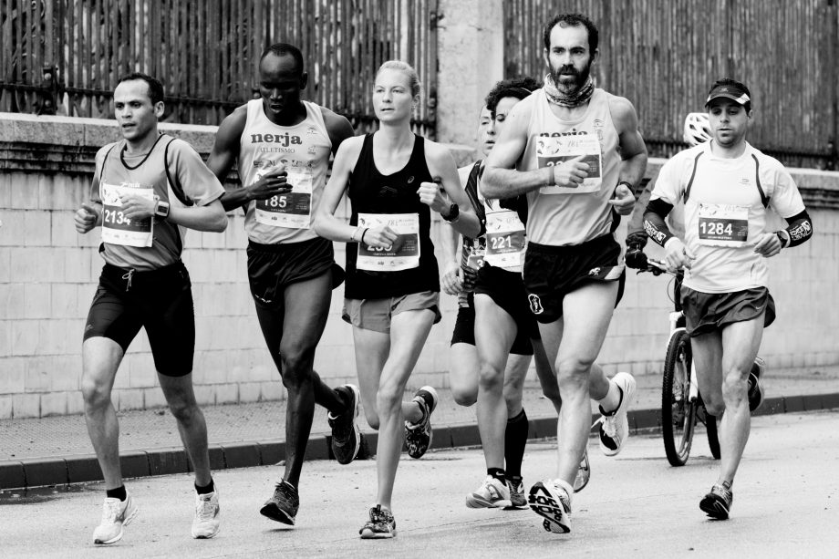 Group of male and female runners in black and white